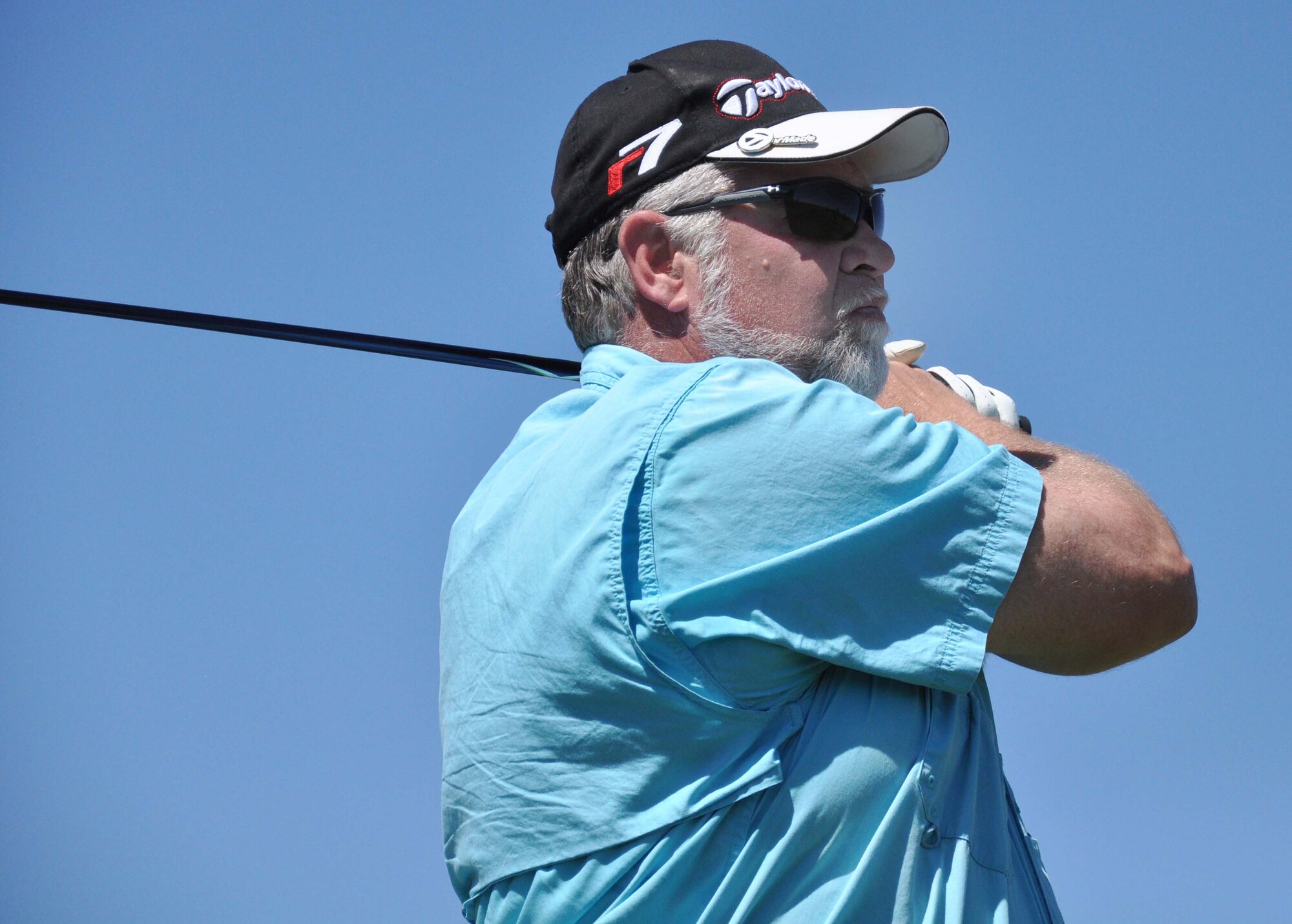 Dave Bartlett, the Transit Center at Manas project manager for URS Berger, watches his ball fly down the fairway during the 3rd Annual Maple Leaf Golf Course "Friends Support You" tournament May 29, 2010. For the second year in a row, his team won first place in the event, which benefitted Ed Miles, the owner of the course, who was diagnosed with bladder cancer this year. (U.S. Air Force photo/Staff Sgt. Carolyn Viss)