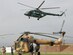 An Afghan National Police helicopter returns from a mission in the Salang Pass and is about to land in front of an Afghan National Army Air Corps Mi-17 during the recovery phase of Pamir Airlines Recovery Mission May 22, 2010, in Parwan, Afghanistan  .  (U.S. Air Force photo by Tech. Sgt. Mike Tateishi/RELEASED)