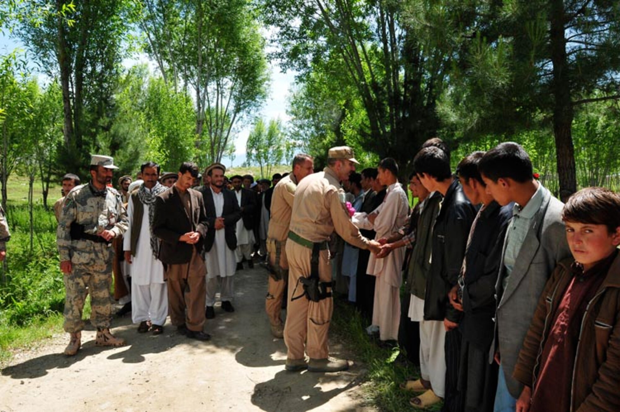 - Villagers greet pilots from the Combined Airpower Transition Force after they delivered a generator May 20, 2010, in Baharak, Afghanistan.  (U.S. Navy Photo by MC1 Elizabeth Burke/RELEASED)