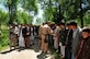 - Villagers greet pilots from the Combined Airpower Transition Force after they delivered a generator May 20, 2010, in Baharak, Afghanistan.  (U.S. Navy Photo by MC1 Elizabeth Burke/RELEASED)