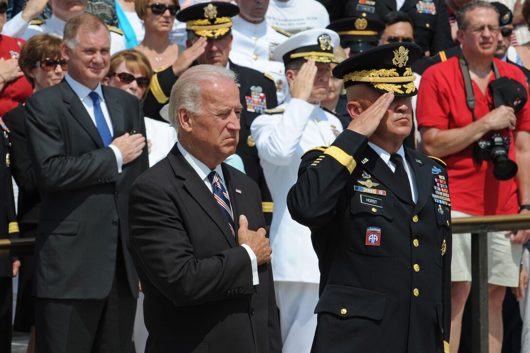 Viice President Joe Biden, accompanied by MaJ. Gen. Karl R. Horst, commander of the Military District of Washington and the Joint Force Headquarters, National Capitol Region, salute at the playing of Taps by the lone bugular during Memorial Day Ceremonies, May 31, 2010, at the Tomb of the Unknowns, Arlington National Cemetery.  Standing in the background at left is Deputy  Secretary of Defense William J. Lynn III, host for the ceremony.