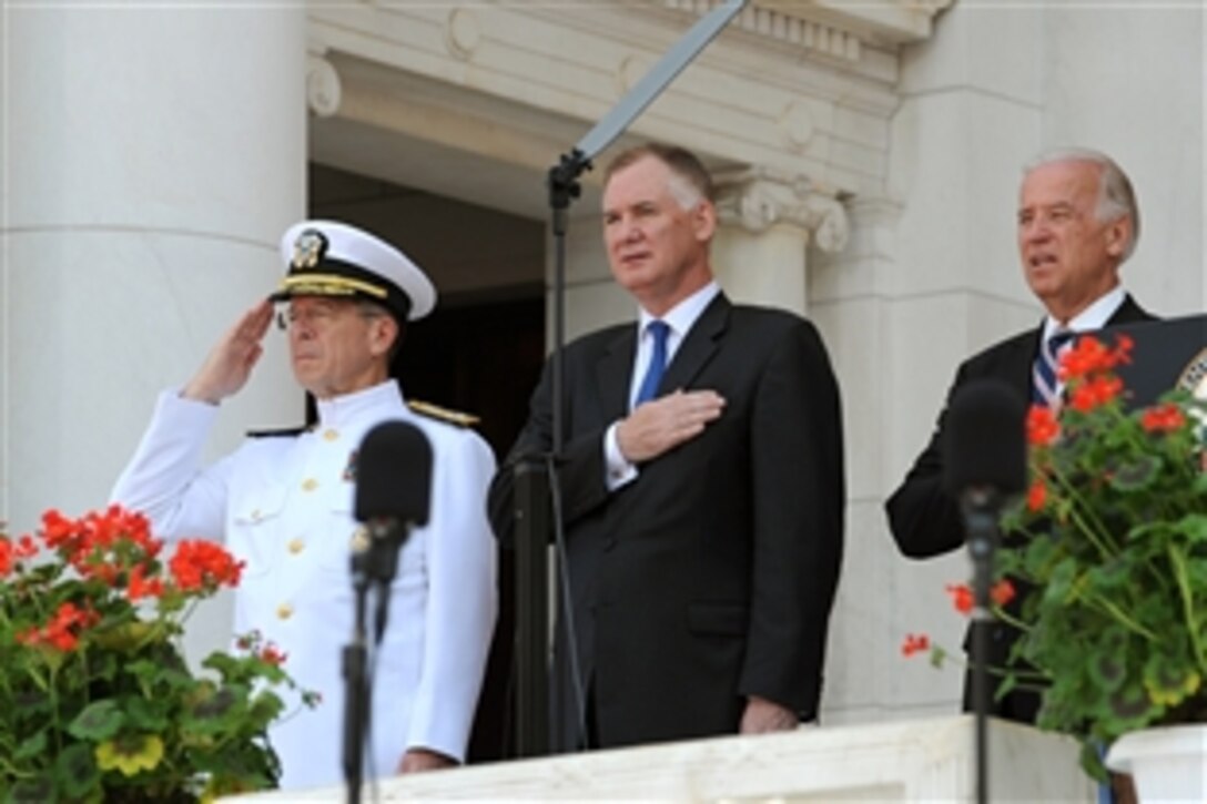 Navy Adm. Mike Mullen, chairman of the Joint Chiefs of Staff, Deputy Secretary of Defense William J. Lynn III, and Vice President Joe Biden - the principals at the annual Memorial Day observance at Arlington National Cemetery, Va.,  - salute and join in the singing of the national anthem, May 31, 2010.