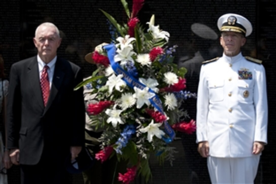 Retired U.S. Army Gen. Barry McCaffery and Navy Adm. Mike Mullen, chairman of the Joint Chiefs of Staff, present a wreath at the annual Memorial Day Observance Ceremony at the Vietnam Veterans Memorial in Washington, D.C., May 31, 2010. Mullen gave the keynote address and recognized the addition of six new names to the over 58,000 service members who perished in that war.