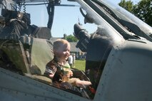 NEW YORK -- A child sits in the cockpit of a AH-1W Cobra helicopter after Marines from Special Purpose Marine Air Ground Task Force New York demonstrate a helicopter raid at Clove Lakes Park, Staten Island, New York, May 31.  More than 3,000 Marines, Sailors and Coast Guardsmen are in the area participating in community outreach events and equipment demonstrations. This is the 26th year New York City has hosted the sea services for Fleet Week. (Official Marine Corps photo by Cpl James Cline / RELEASED)