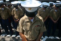 PELHAM, N. Y. - Special Purpose Marine Air Ground Task Force New York Marines bow their heads during the invocation ahead of Memorial Day ceremonies in Pelham, N.Y May 31. The Marines marched through town with sailors, retired veterans, fire fighters and police.  The Marines were on hand as part of Fleet Week New York 2010. This is the 26th year New York City has hosted the sea services for Fleet Week.