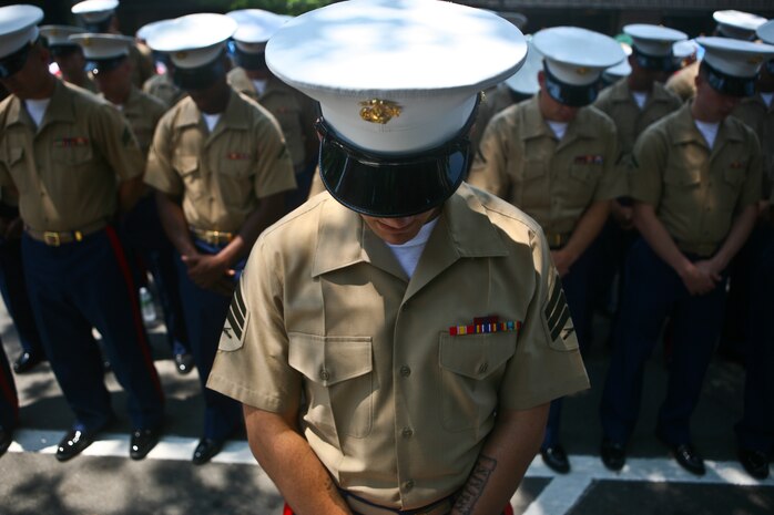 PELHAM, N. Y. - Special Purpose Marine Air Ground Task Force New York Marines bow their heads during the invocation ahead of Memorial Day ceremonies in Pelham, N.Y May 31. The Marines marched through town with sailors, retired veterans, fire fighters and police.  The Marines were on hand as part of Fleet Week New York 2010. This is the 26th year New York City has hosted the sea services for Fleet Week.