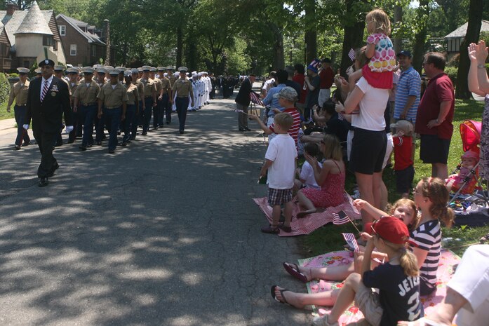 PELHAM, N.Y. - Pelham residents cheer as Special Purpose Marine Air Ground Task Force New York Marines march by as part of the town's Memorial Day ceremonies May 31. The Marines were on hand as part of Fleet Week New York 2010. This is the 26th year New York City has hosted the sea services for Fleet Week. More than 3,000 Marines, Sailors and Coast Guardsmen are in the area participating in community outreach events and equipment demonstrations. This is the 26th year New York City has hosted the sea services for Fleet Week.