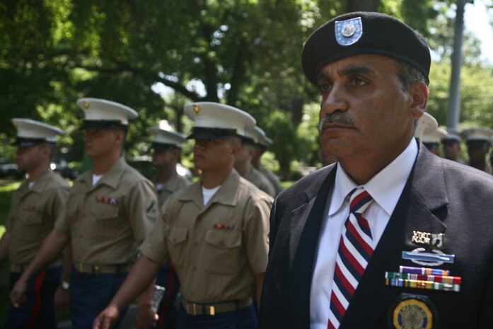 PELHAM, N. Y. - James Dike, a retired Army Vietnam veteran and member of the American Legion Post 50 in Pelham, leads a formation of Marines as they march as part of the town's Memorial Day ceremonies May 31. The Marines were on hand as part of Fleet Week New York 2010. This is the 26th year New York City has hosted the sea services for Fleet Week. More than 3,000 Marines, Sailors and Coast Guardsmen are in the area participating