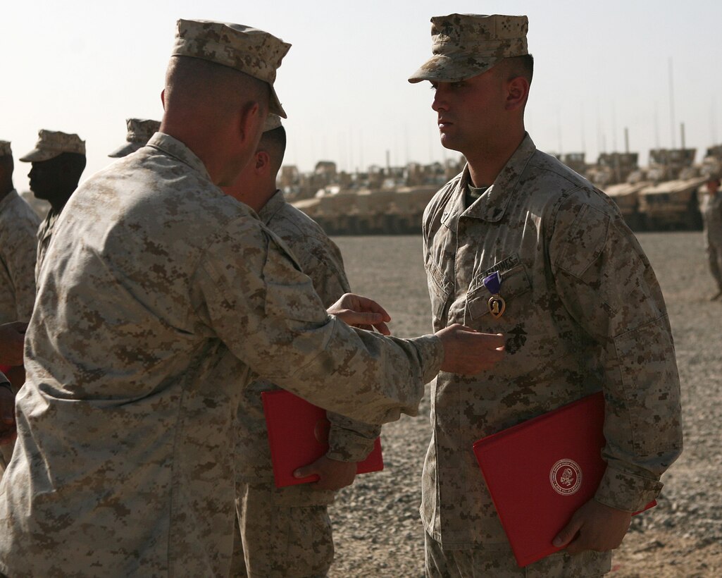 Lance Cpl. Zachary Lohr, a military policeman with Alpha Company, Combat Logistics Battalion 6, 1st Marine Logistics Group (Forward), is awarded the Purple Heart medal from his commanding officer, Lt. Col. Mike Lepson, during a Memorial Day service and awards ceremony aboard Camp Leatherneck, Afghanistan, May 31. Lohr, along with four others, received the medal in recognition of wounds sustained during actions in direct service support of combat operations in Helmand province.