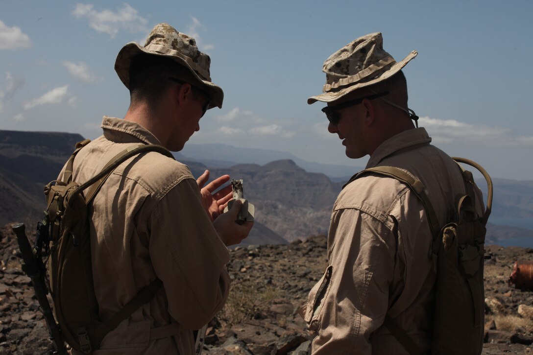 Sergeant Jeremy Schuch, left, and Gunnery Sergeant Matthew Grant, both Explosive Ordnance Disposal (EOD) technicians with Combat Logistics Battalion 26, 26th Marine Expeditionary Unit,  examine fragments of exploded ordnance during range clearing operations in Djibouti, Africa, Nov. 1, 2010.  Elements of 26th MEU conducted sustainment training for their current deployment at Camp Lemonnier and surrounding areas.