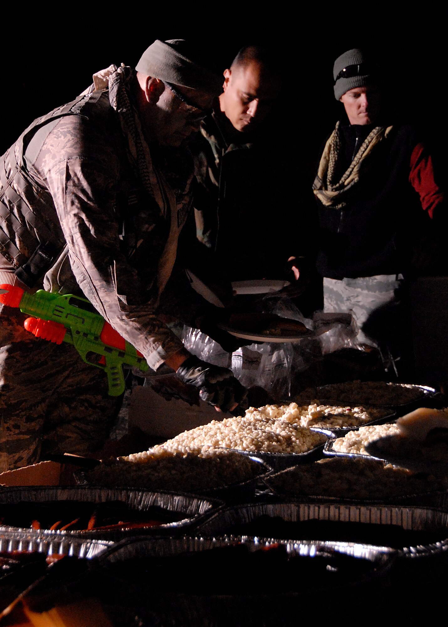 Airmen from the 8th Fighter Wing line up to feast on sides to accompany their grilled hamburgers and hot dogs at the Combat Dining-In here Oct. 30.  The event was held to boost esprit de corps and honor military traditions.  (U.S Air Force photo/Capt. Sheryll Klinkel)