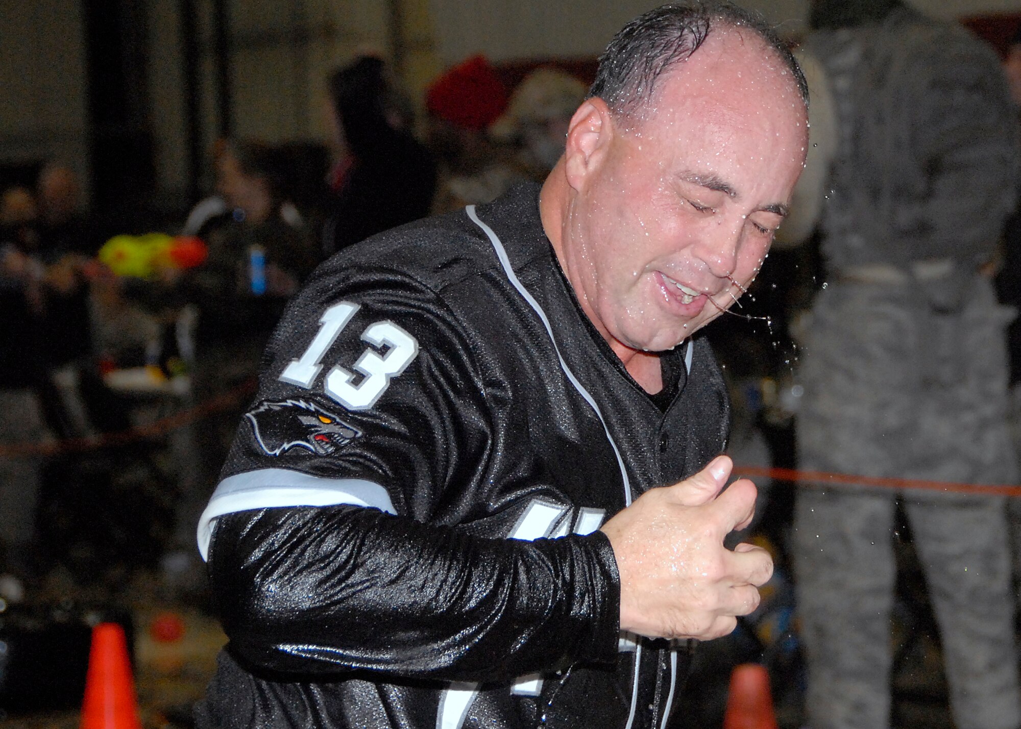 Chief Master Sgt. James Sanders, 8th Fighter Wing command chief, wipes the water from his face after completing the combat obstacle course that lead to the grog bowl at the Combat Dining-In here Oct. 30.  The chief was sent to the grog for violating rule No. 6 of the mess, which prohibited attendees from “clapping thy hands”.  (U.S Air Force photo/Capt. Sheryll Klinkel)