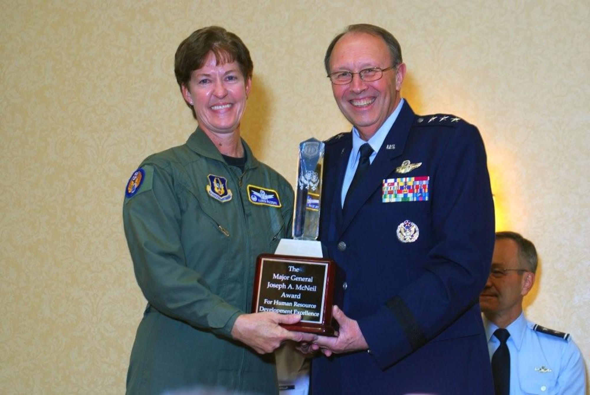 310th Space Wing Commander, Col. Karen Rizzuti accepts the Maj. Gen. Joseph A. McNeil Award for  Human Resources Development Council Leadership Excellence from Lt. Gen. Charles E. Stenner Jr. at the HRDC workshop in Atlanta on Oct. 27. (Courtesy photo)