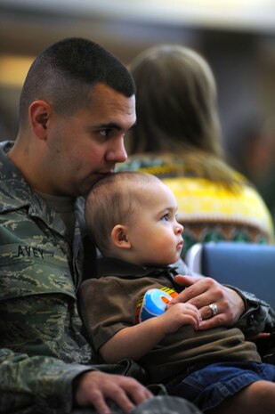 Senior Airman Jacob Avey sits with his son Brandon on his lap as he prepares to deploy with the 16th Airlift Squadron on Joint Base Charleston, S.C., Oct. 28, 2010. This is Airman Avey's second deployment during his Air Force career, but the first away from his children. Airman Avey will be deployed to the Middle East for four months. Airman Avey is an aircrew flight equipment journeyman with the 16 AS. (U.S. Air Force Photo/Airman 1st Class Lauren Main)