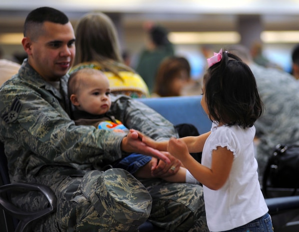 Senior Airman Jacob Avey sits surrounded by his family as he prepares to deploy with the 16th Airlift Squadron on Joint Base Charleston, S.C., Oct. 28, 2010. This is Airman Avey's second deployment during his Air Force career, but the first away from his children. Airman Avey will be deployed to the Middle East for four months. Airman Avey is an aircrew flight equipment journeyman with the 16 AS. (U.S. Air Force Photo/Airman 1st Class Lauren Main)