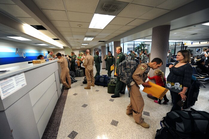 Airmen from the 16th Airlift Squadron wait in line to check their bags at the passenger terminal on Joint Base Charleston, S.C., as they prepare to deploy Oct. 28, 2010. The squadron will be deployed to the Middle East for four months. (U.S. Air Force Photo/Airman 1st Class Lauren Main)