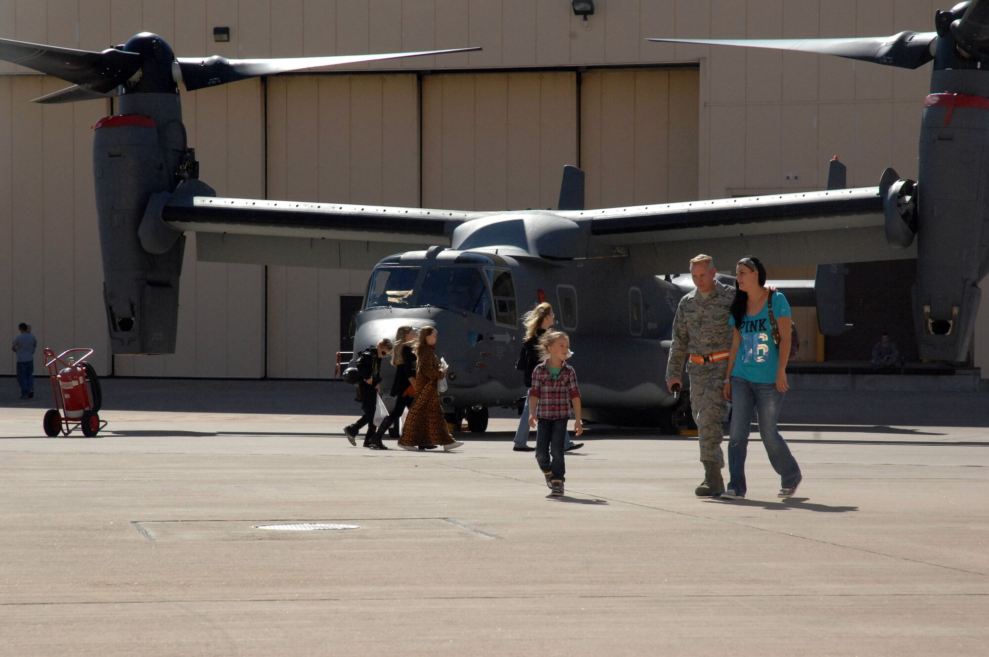 Airmen and their families enjoy the CV-22 Osprey static display during the fall festival held in Hangar 208 here October 30. The event featured aircraft displays, food, games, information booths and more. (U.S. Air Force photo by Senior Airman Elliott Sprehe)