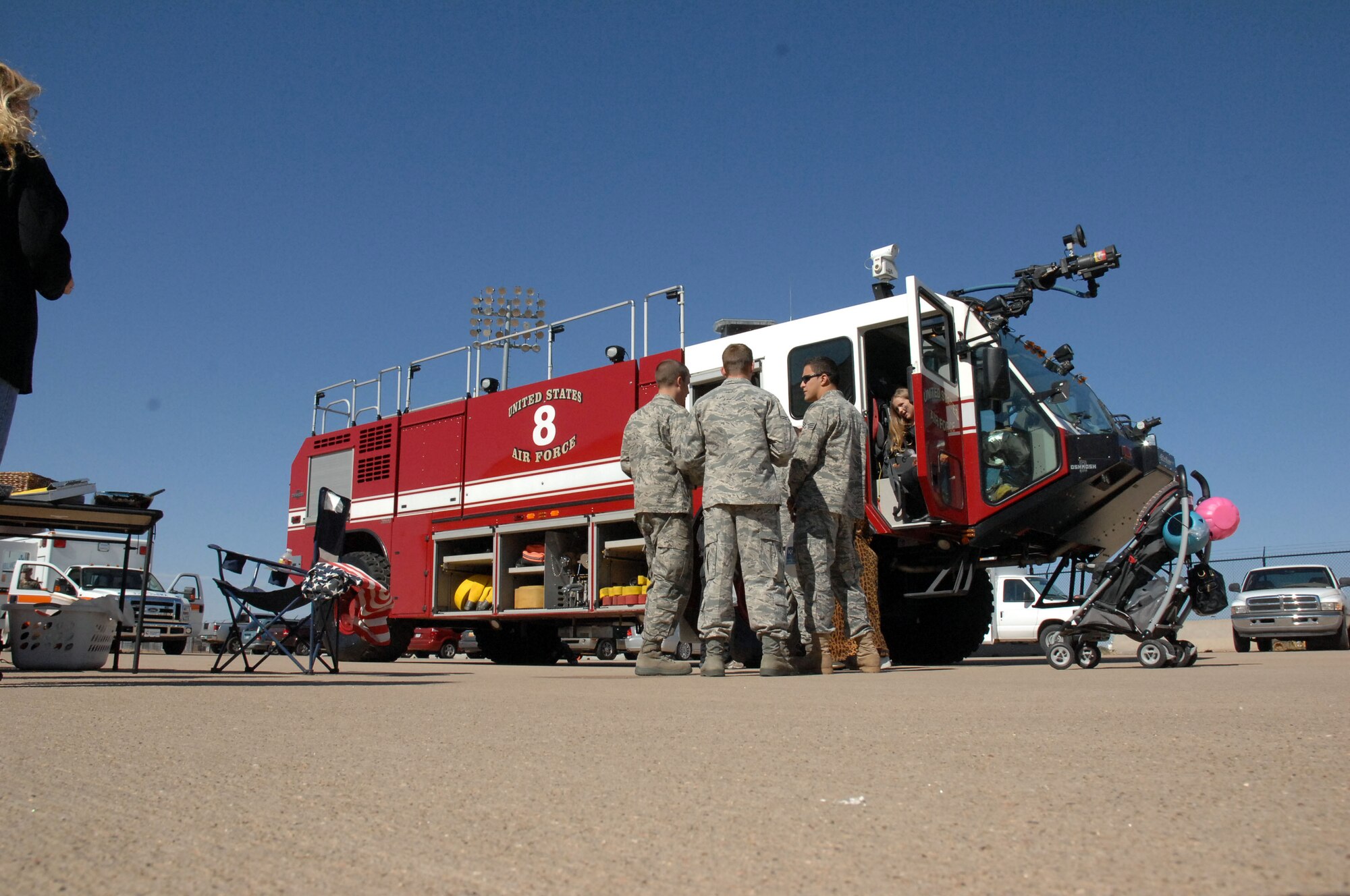 Airmen and their families enjoy the base fire department's display during the fall festival held in Hangar 208 here October 30. The event featured aircraft displays, food, games, information booths and more. (U.S. Air Force photo by Senior Airman Elliott Sprehe)