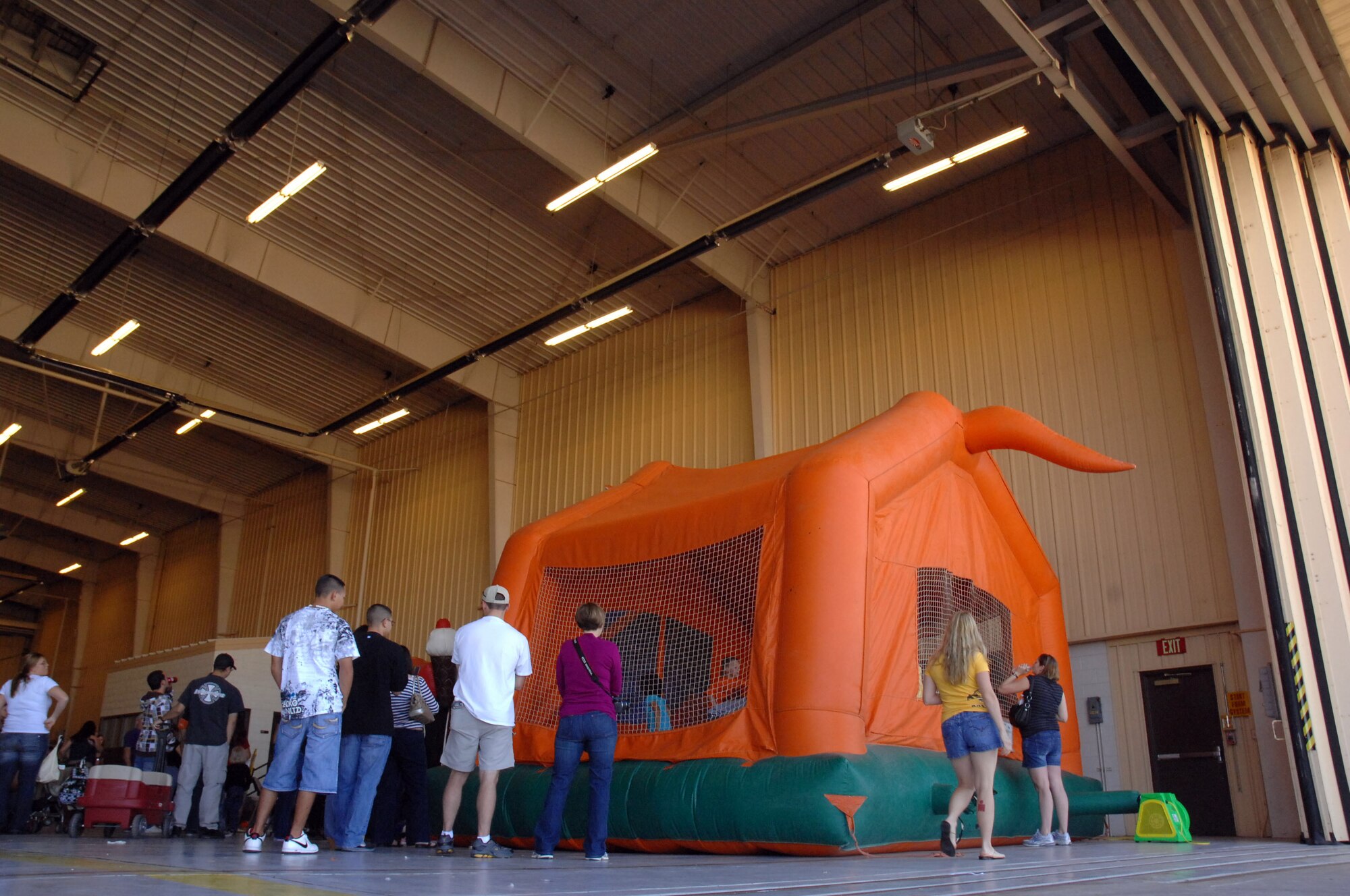 Airmen and their families enjoy the bouncy castle during the fall festival held in Hangar 208 here October 30. The event featured aircraft displays, food, games, information booths and more. (U.S. Air Force photo by Senior Airman Elliott Sprehe)