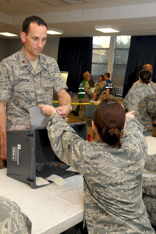 LANGLEY AIR FORCE BASE, Va -- Maj. Greg Garrison, 633d Aerospace Medical squadron Bio-Environmental Engineering flight commander, receives his dosage of the anti-viral Tamiflu, during the Public Disease Outbreak Exercise Oct. 28. This second annual Major Accident Response Exercise involving a disease outbreak is designed to evaluate the distribution of the prophylactic influenza to 5,000 personnel in 48 hours in case of a pandemic outbreak on base. (U.S. Air Force photo/Staff Sgt. Ashley Hawkins)(RELEASED)