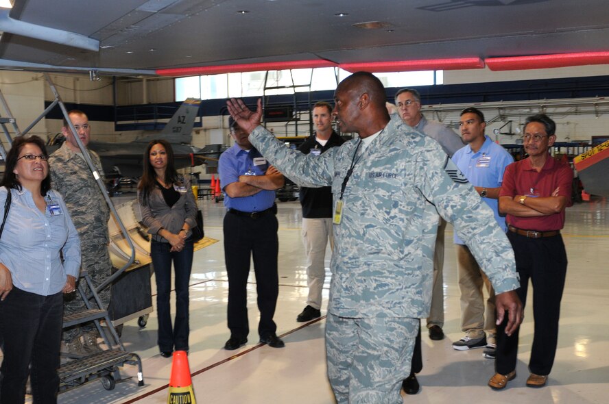 Master Sgt. Pete Smith, an aircraft maintenance supervisor at Arizona’s 162nd Fighter Wing, shows employers several aspects of F-16 phase maintenance during Business and Industry Days Oct. 28. (U.S. Air Force photo/Maj. Gabe Johnson)