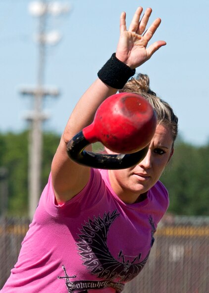 Jeana Quintana, 96th Logistics Readiness Squadron, releases the 25-pound kettle bell during the kettle toss competition at Eglin’s first ever Strongman Competition Oct. 29.  20 of Eglin’s top men and women competed in four events to determine who was the base’s strongest.  Quintana placed first in her division.  (U.S. Air Force photo/Samuel King Jr.)