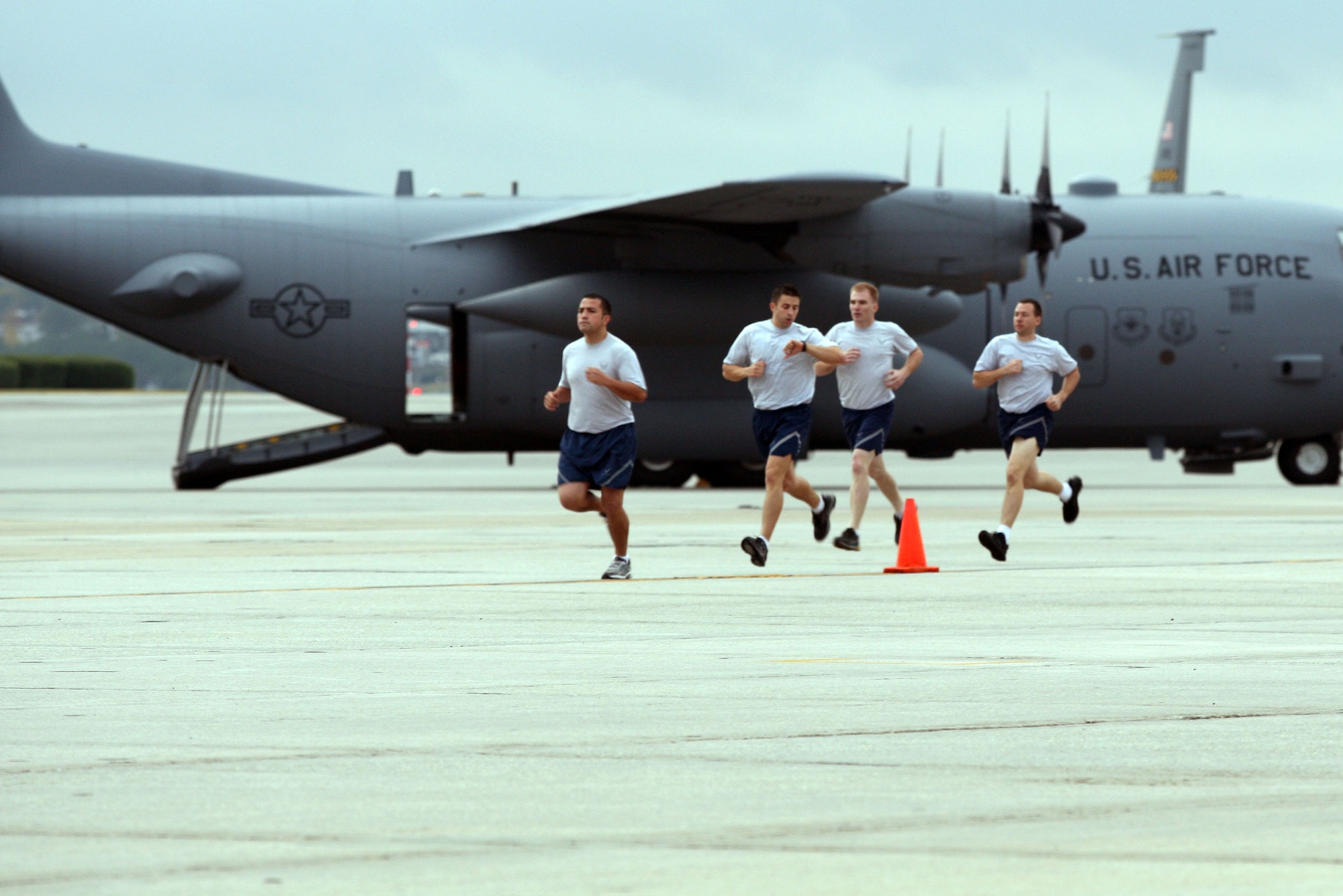 A step ahead of the competition, Tech. Sgt. Cody De Los Reyes, Senior Airman Sterling Broadhead, and Tech. Sgt. Charles Drinkwater run laps on the tarmac at Dobbins Air Reserve Base, Ga. The team from the 419th Fighter Wing’s 67th Aerial Port Squadron took first place in the fit-to-fight event at Air Force Reserve Command’s Port Dawg Challenge last week. (U.S. Air Force photo/Don Peek)