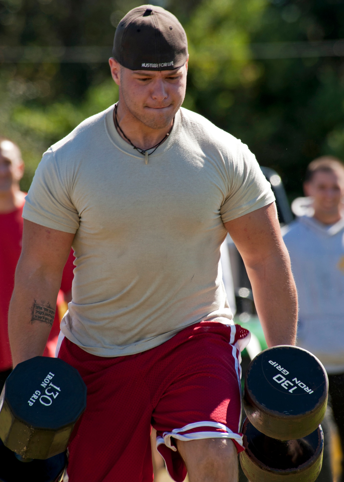 Andrew Opel, 96th Force Support Squadron, carries two 130 pound dumbbells during the “farmer’s carry” event at Eglin’s first ever Strongman Competition Oct. 29.  20 of Eglin’s top men and women competed in four events to determine who was the base’s strongest.  Opel took home the top prize in the heavyweight division.  (U.S. Air Force photo/Samuel King Jr.)