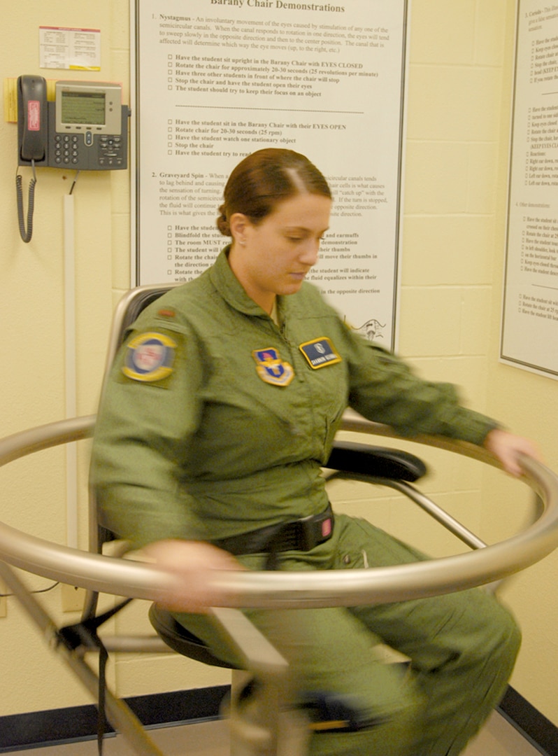 2nd Lt. Shannon Scannon spins slowly in a Barany chair used to help prevent air sickness. Lieutenant Scannon is a physiologist with the 359th Aerospace Medical Squadron (U.S. Air Force photo/Brian McGloin)