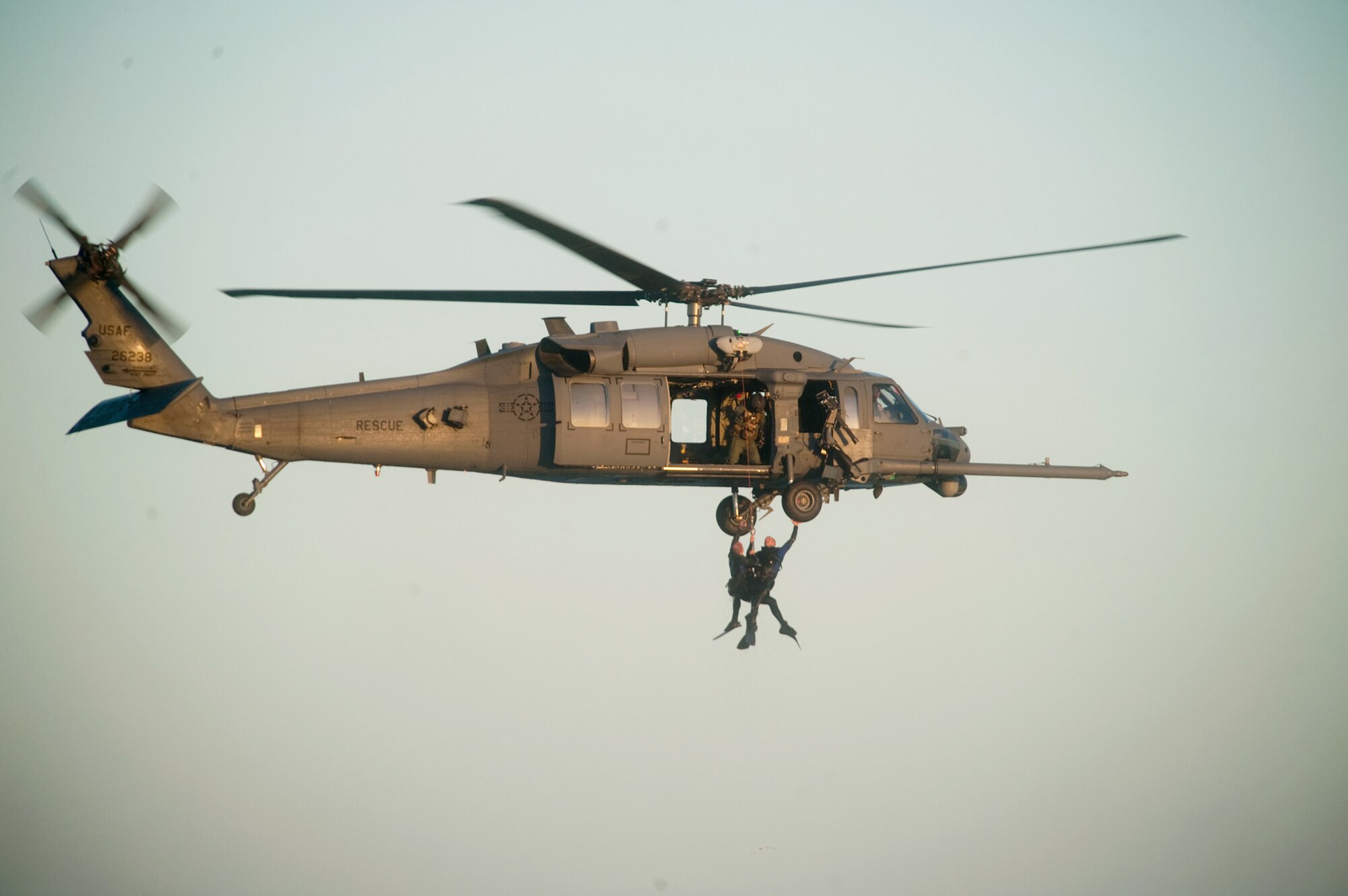 Pararescuemen grab a tire before the final lift into HH-60 Pave Hawk during an Air Force Week rescue demonstration Oct. 27, 2010, at Cocoa Beach, Fla. The pararescuemen are from the 920th Rescue Wing at Patrick Air Force Base, Fla. (U.S. Air Force photo/Lance Cheung)