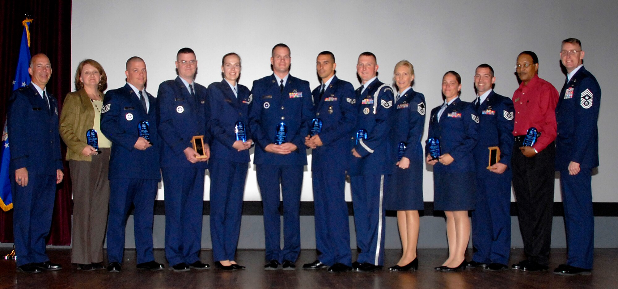 Quarterly award winners for the 82nd Training Wing stand in unison Oct. 29 following a recognition event at the Sheppard Air Force Base theater. Those picture include (left to right): Col. Michael Hake, 82nd TRW vice commander; Laura McRee, 82nd CONS, Category II Civilian Supervisor of the Quarter; Tech. Sgt. Eric Helms, 365th TRS, Junior Military Training Leader of the Quarter; Capt. Chad Wigginton, 363rd TRS, CGO Instructor of the Quarter; Capt. Ramona Daugherty, 882nd Training Support Squadron, Company Grade Officer of the Quarter; Tech. Sgt. Brian Sherrod, 361st TRS, Flight Chief of the Quarter; Senior Airman Stephen Pillitiere, 82nd Security Forces Squadron, Airman of the Quarter; Staff Sgt. Douglas Johnson, 362nd TRS, NCO Honor Guardsman of the Quarter; Master Sgt. Carol Swapp, 373rd Training Squadron, Senior NCO of the Quarter; Staff Sgt. Jasmine Burdick, 361st TRS, Military Volunteer of the Quarter; Tech. Sgt. Kristopher Eddy, 361st TRS, NCO Instructor of the Quarter; Chrispus Taylor, 364th TRS, Civilian Volunteer of the Quarter; and Chief Master Sgt. David Nelson, 82nd TRW command chief master sergeant. Other winners not pictured include: Tech. Sgt. Leon Egleston, 82nd Force Support Squadron, NCO of the Quarter; Senior Airman Scott Campbell, 372nd TRS, Detachment 14, Airman Instructor of the Quarter; Master Sgt. Lester Braithwaite, 373rd TRS, Detachment 20, Senior NCO Instructor of the Quarter; Frank Bonifaz, 361st TRS, Civilian Instructor of the Quarter; Chris Lamiroult, 82nd Contracting Squadron, Category II Civilian of the Quarter; Marta Garcia, 82nd Dental Squadron, Category I Civilian of the Quarter; and Master Sgt. Kevin Wilske, 362nd TRS, Senior MTL of the Quarter. (U.S. Air Force photo/Mike Litteken)