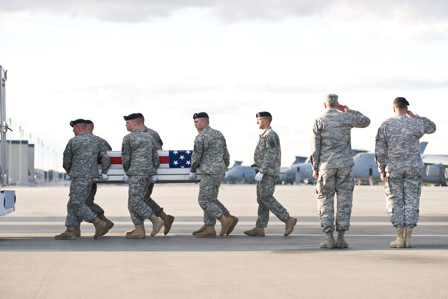 A U.S. Army carry team transfers the remains of Army Staff Sgt. Adam L. Dickmyer, of Winston Salem, N.C., at Dover Air Force Base, Del., Oct. 29, 2010. Dickmyer was assigned to the 2nd Battalion, 502nd Infantry Regiment, 2nd Brigade Combat Team, 101st Airborne Division (Air Assault), Fort Campbell, Ky. (U.S. Air Force photo/Roland Balik)