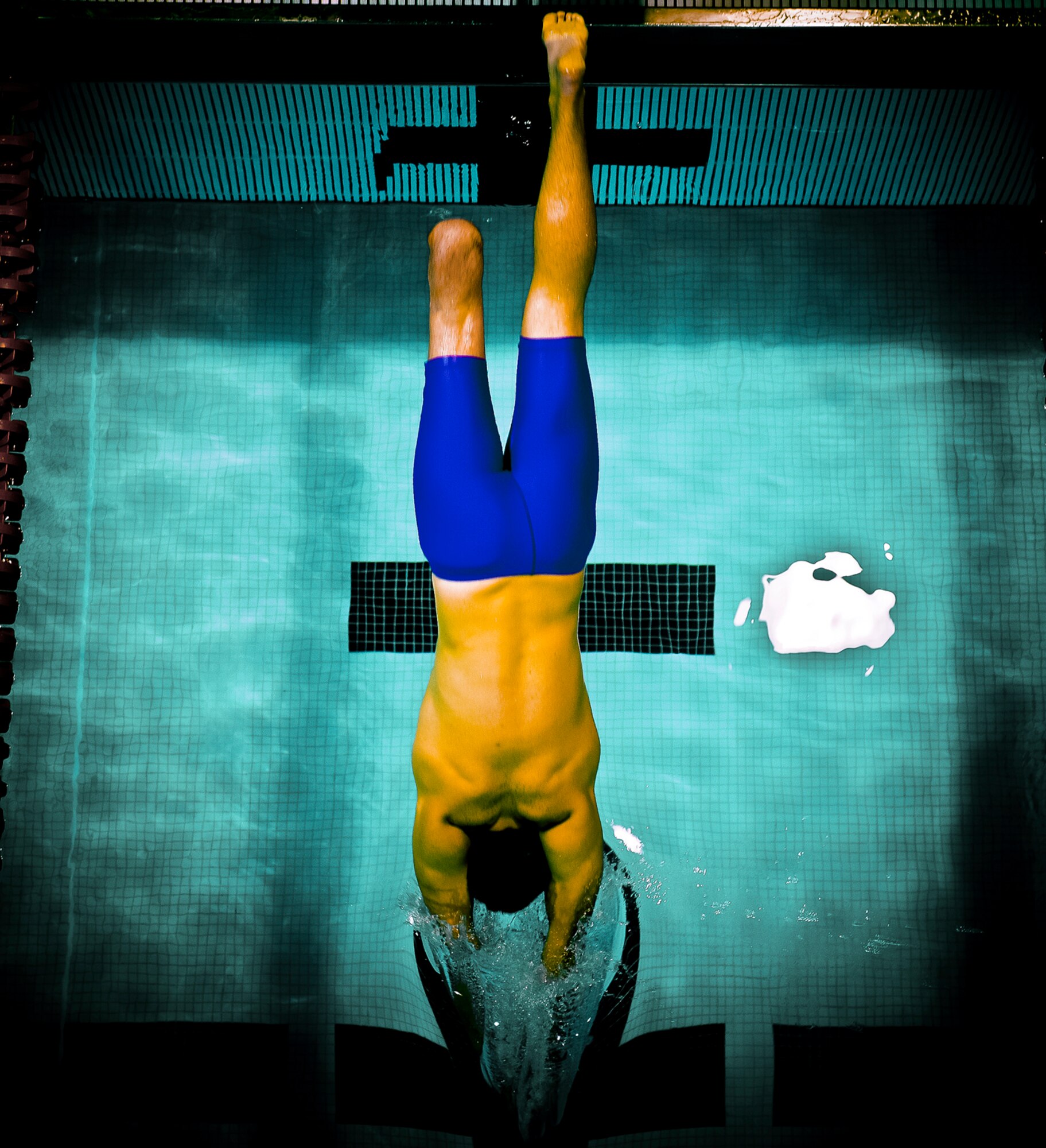 1st Lt. Ryan McGuire dives into the pool to compete in the 100m freestyle where he earned the bronze medal during the Warrior Games May 12, 2010, in Colorado Springs, Colo. (U.S. Air Force photo/Tech. Sgt. Samuel Bendet)