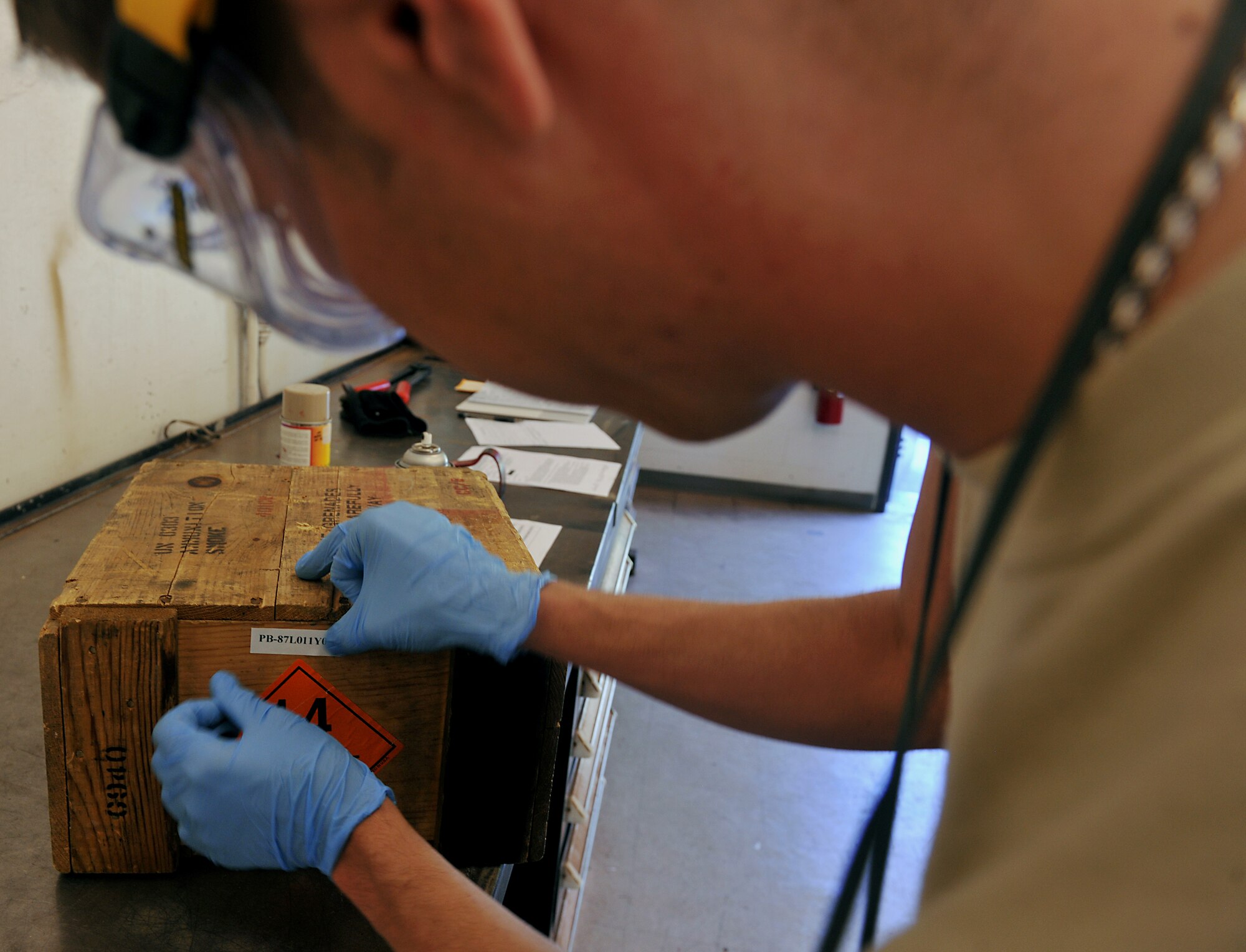 MOODY AIR FORCE BASE, Ga. -- An Airman from the 23rd Equipment Maintenance Squadron munitions flight places a label on packaging munitions box here Nov. 1. Every munitions package has special guidelines and must be labeled and sprayed with a specific color paint. (U.S. Air Force photo/Airman 1st Class Joshua Green)(RELEASED)
