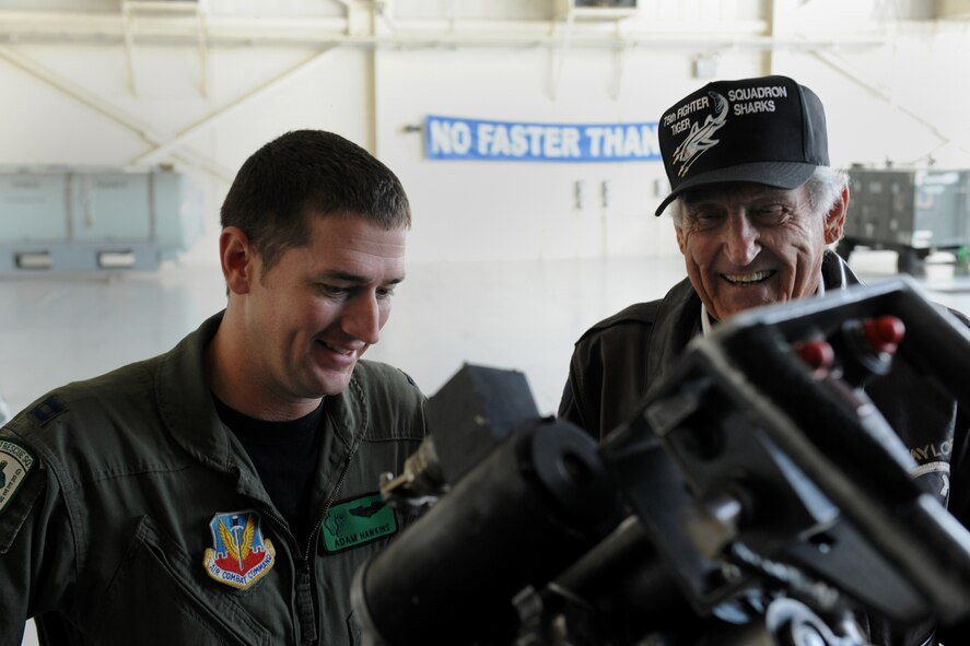 MOODY AIR FORCE BASE, Ga. -- Capt. Adam Hawkins, 41st Rescue Squadron HH-60G Pavehawk pilot, explains the high munitions capabilities of the helicopter to retired Col. J.M. Taylor, retired member of the Fighting Tigers, during the Flying Tiger Reunion here Oct. 30. Members who attended the Flying Tiger Reunion had the opportunity to see the three aircrafts featured at Moody: the A-10C Thunderbolt II, the HC-130P Combat King and the HH-60 Pavehawk. (U.S. Air Force photo/Airman 1st Class Benjamin Wiseman)(RELEASED)
