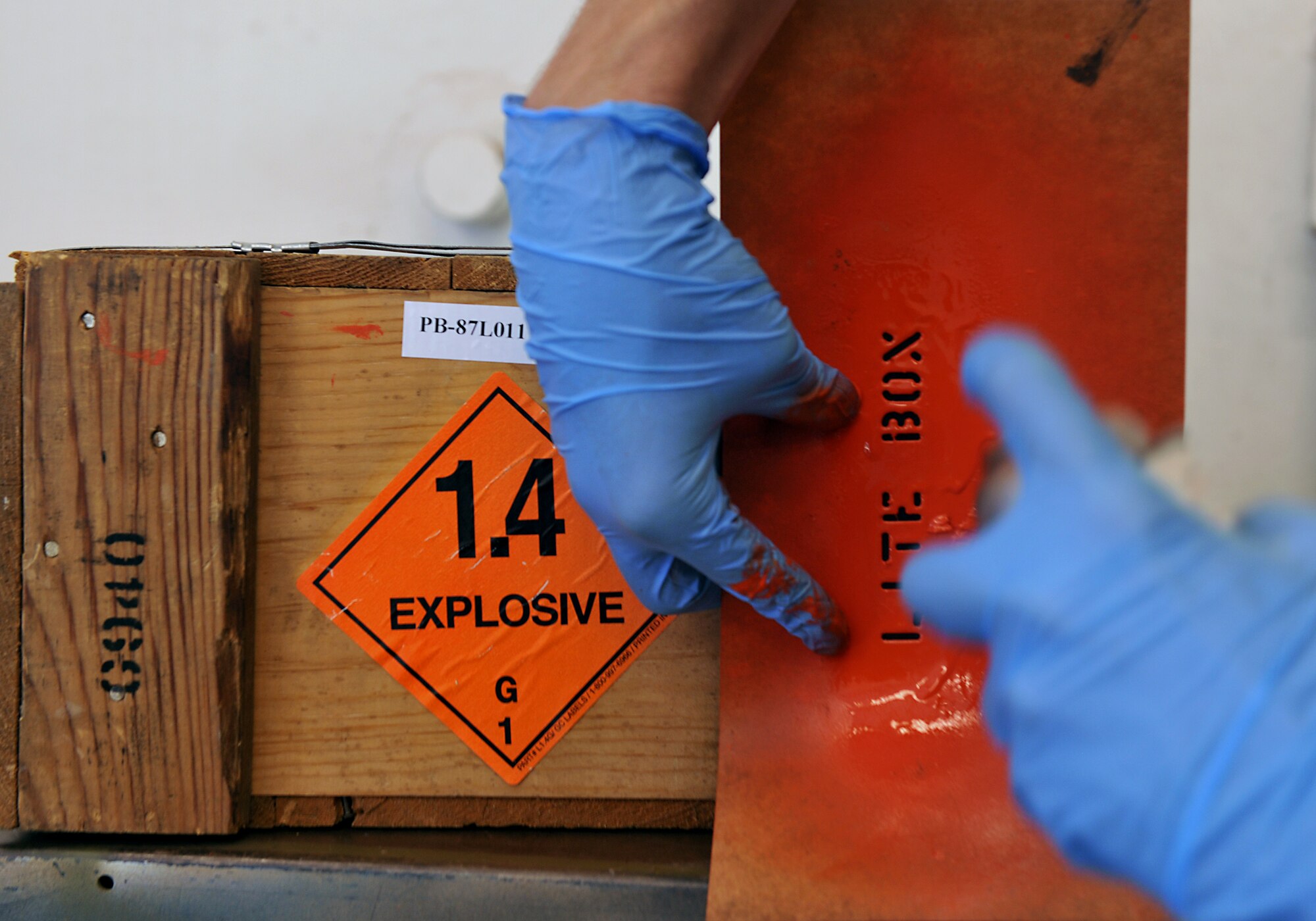 MOODY AIR FORCE BASE, Ga. -- A sticker is labeled with the weight of the explosive on the package while a specific color of paint is applied to the box during munitions inspector training course here Nov 1. The size and color of the explosive gives specific meaning to how the package should be transported and handled. (U.S. Air Force photo/Airman 1st Class Joshua Green)(RELEASED)
