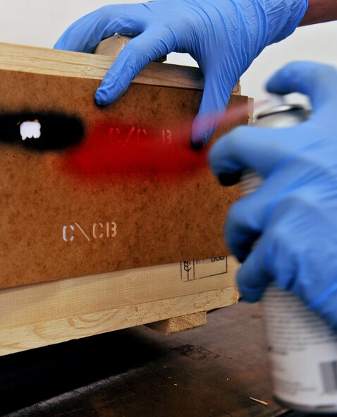MOODY AIR FORCE BASE, Ga. -- An Airman from the 23rd Equipment Maintenance Squadron munitions flight sprays paint on a label using a stencil while packaging munitions here Nov. 1. The munitions flight is completing a munitions inspector training course for individuals who needed to get qualified. (U.S. Air Force photo/Airman 1st Class Joshua Green)(RELEASED) 

