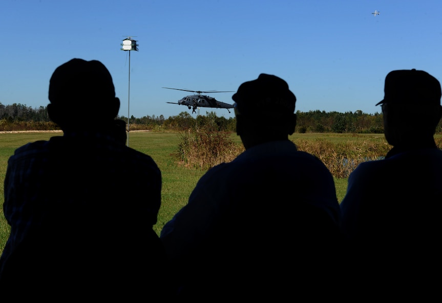 MOODY AIR FORCE BASE, Ga. -- Three retired members of the Flying Tigers watch a combat search and rescue demonstration by the 347th Rescue Group and 23rd Fighter Group during the Flying Tiger Reunion here Oct. 30. Retired Flying Tigers and other military members were shown Moody’s combat capabilities. (U.S. Air Force photo/Airman 1st Class Benjamin Wiseman)(RELEASED)