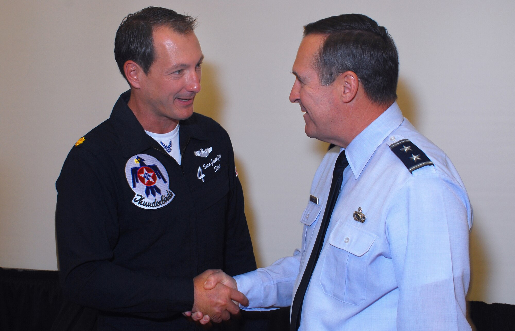 Maj. Sean Gustafson of the U.S. Air Force Air Demonstration Squadron “Thunderbirds” is welcomed to the workshop by Maj. Gen. Stephen P. Gross. Major Gustafson is Thunderbird #4, flying the slot position in the diamond formation and is the first Air Force Reserve pilot to be assigned to the team.  (U.S. Air Force photo/ Brad Fallin)