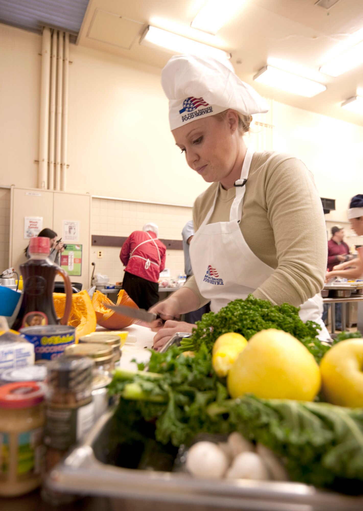 Staff Sgt. Sarah Marlow dices pumpkin and vegetables for the second annual "Fit to Fight" Iron Chef competition Oct. 27, 2010, at Misawa Air Base, Japan. Fresh pumpkin was the secret ingredient required to be used in all of the dishes. Sergeant Marlow is a 35th Judge Advocate Civil Law paralegal. (U.S. Air Force photo/Airman James B. Bauer)