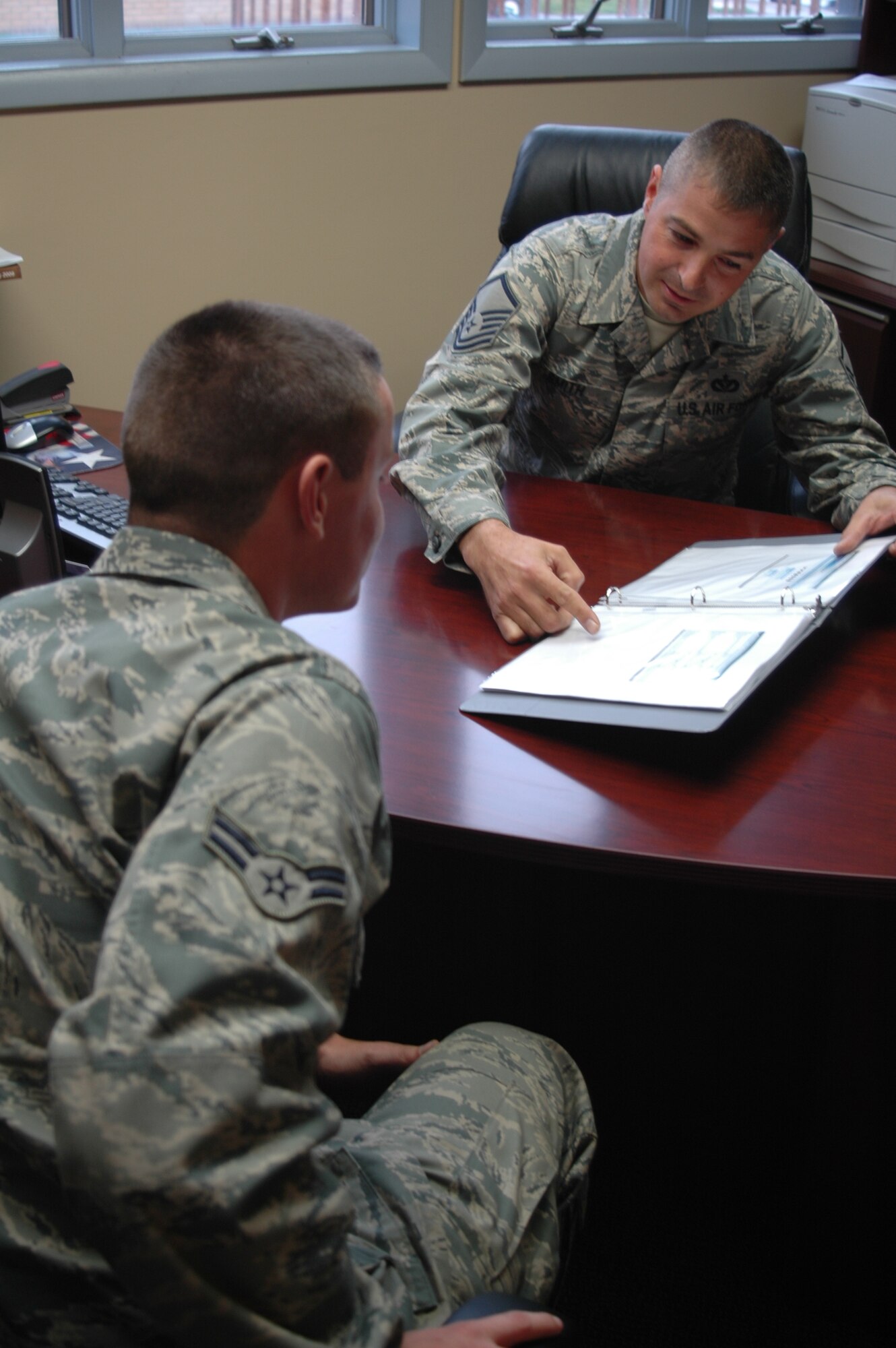 Master Sgt. William Smith, 341st Missile Wing career assistance advisor, speaks with Airman 1st Class Joshua Wood, 341st Missile Maintenance Squadron member, about opportunities in the Air Force. The session was Oct. 5 in building 581. (U.S. Air Force photo/Staff Sgt. Dillon White)
