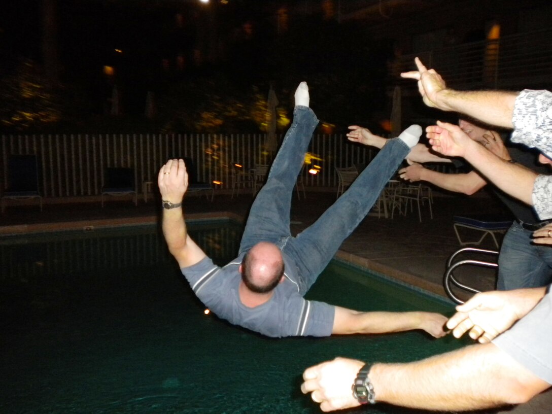 In one of the USAF Academy Band's most time-honored traditions, band members hurl a retiring bandsman into the hotel pool on the last day of his last tour. Here, band members bid a fond farewell to Chief Master Sergeant Scott Barbier, who served the US Air Force as percussionist, administrator, and leader for 30 years.