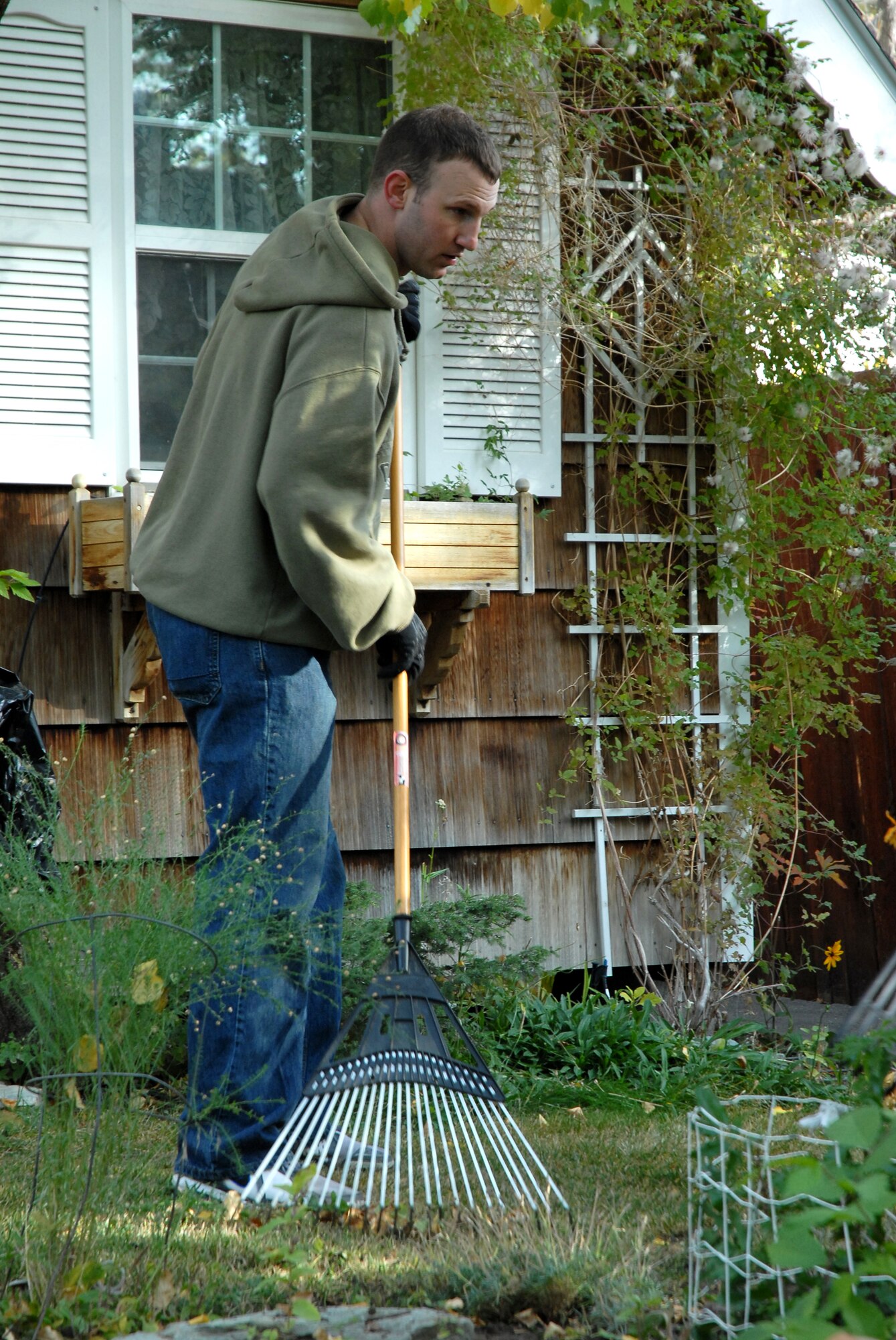 Staff Sgt. Kevin Pennington, 341st Logistics Readiness Squadron NCO in charge of allied trades, rakes leaves for a member of the local community Oct. 22 during the Day of Caring in Great Falls, Mont. Sergeant Pennington was one of more than 170 volunteers from Malmstrom Air Force Base who helped elderly and disabled people by completing tasks they can no longer do themselves. (U.S. Air Force photo/Staff Sgt. Dillon White)