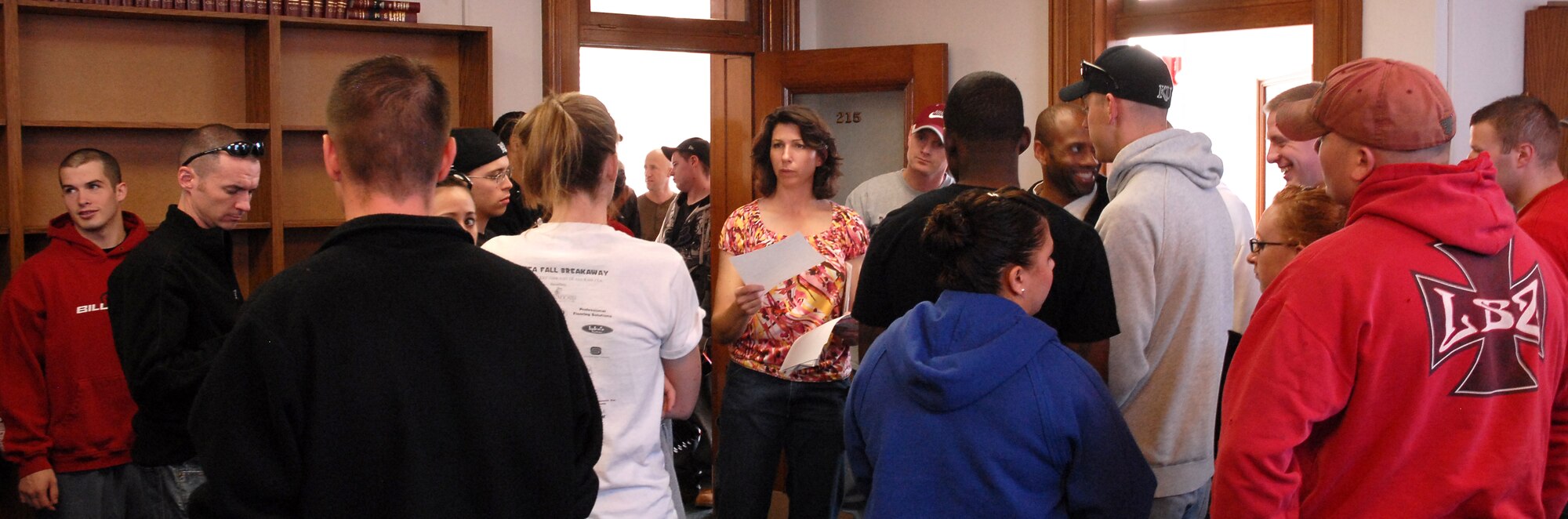 Center, Nancy Donovan, Great Falls Post Office secretary to the post master and Day of Caring coordinator, passes out work requests to Malmstrom Total Force Airmen and Federal emplyees Oct. 22 at the Great Falls Post Office. (U.S. Air Force photo/Staff Sgt. Dillon White)
