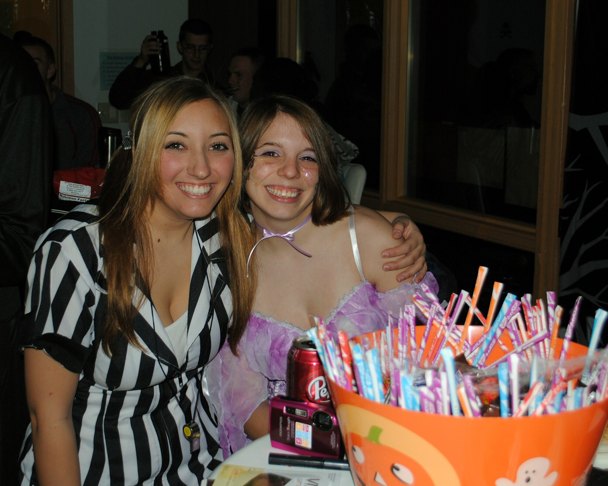 Airmen 1st Class Courtney Taylor and Shelby Benson, 341st Comptroller Squadron customer service technicians, pause for a photo at the Airman’s Council Halloween party Oct. 22.(U.S. Air Force photo/Airman 1st Class Kristina Overton)