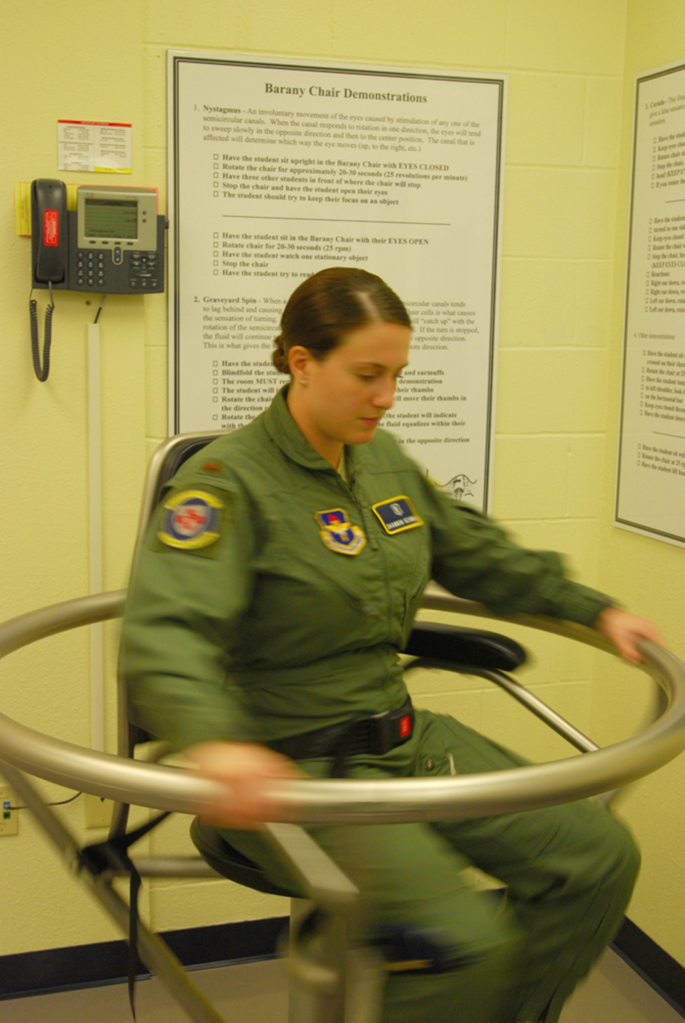 2nd Lt. Shannon Scannon, 359th Aerospace Medical Squadron aerospace and operations physiologist, spins slowly in a Barany chair.(U.S. Air Force photo/Brian McGloin)