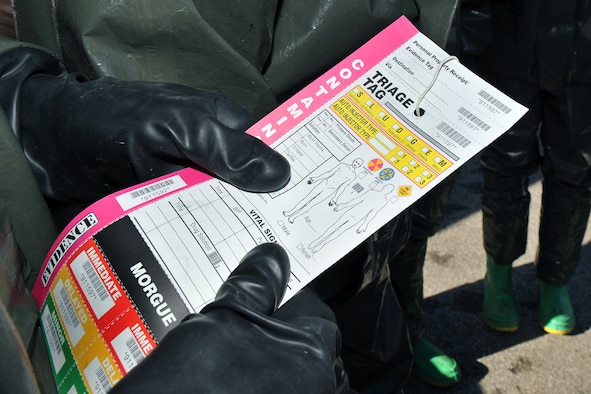 OFFUTT AIR FORCE BASE, Neb. -- Staff Sgt. Clayton Perry, a member of the 55th Medical Group, holds a triage tag card during a decontamination exercise outside the Erhling Bergquist Clinic here Oct. 22. The training required 17 medics to process a litter-bound dummy and two ambulatory "patients" through four decontamination stations -- undress, wash, rinse and redress.  The litter-bound dummy started the decontamination process by going through a triage station as well to assess its injuries.

U.S. Air Force photo by Charles Haymond
[RELEASE] by Deborah Aragon