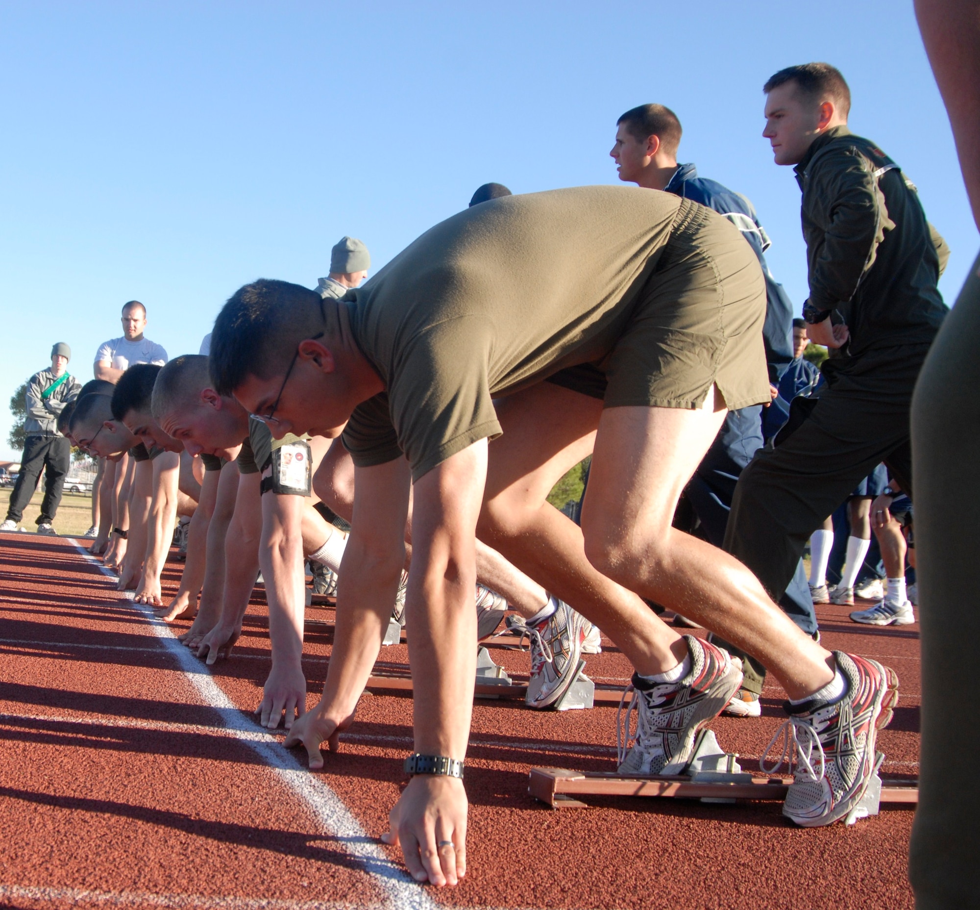 GOODFELLOW AIR FORCE BASE, Texas - The Marine Corps Detachment running team gets set for take off during the 100 meters dash held at the 17th Training Wing Quarterly Sports Day, Oct. 29. (U.S. Air Force photo/Airman 1st Class Anne Gathua)