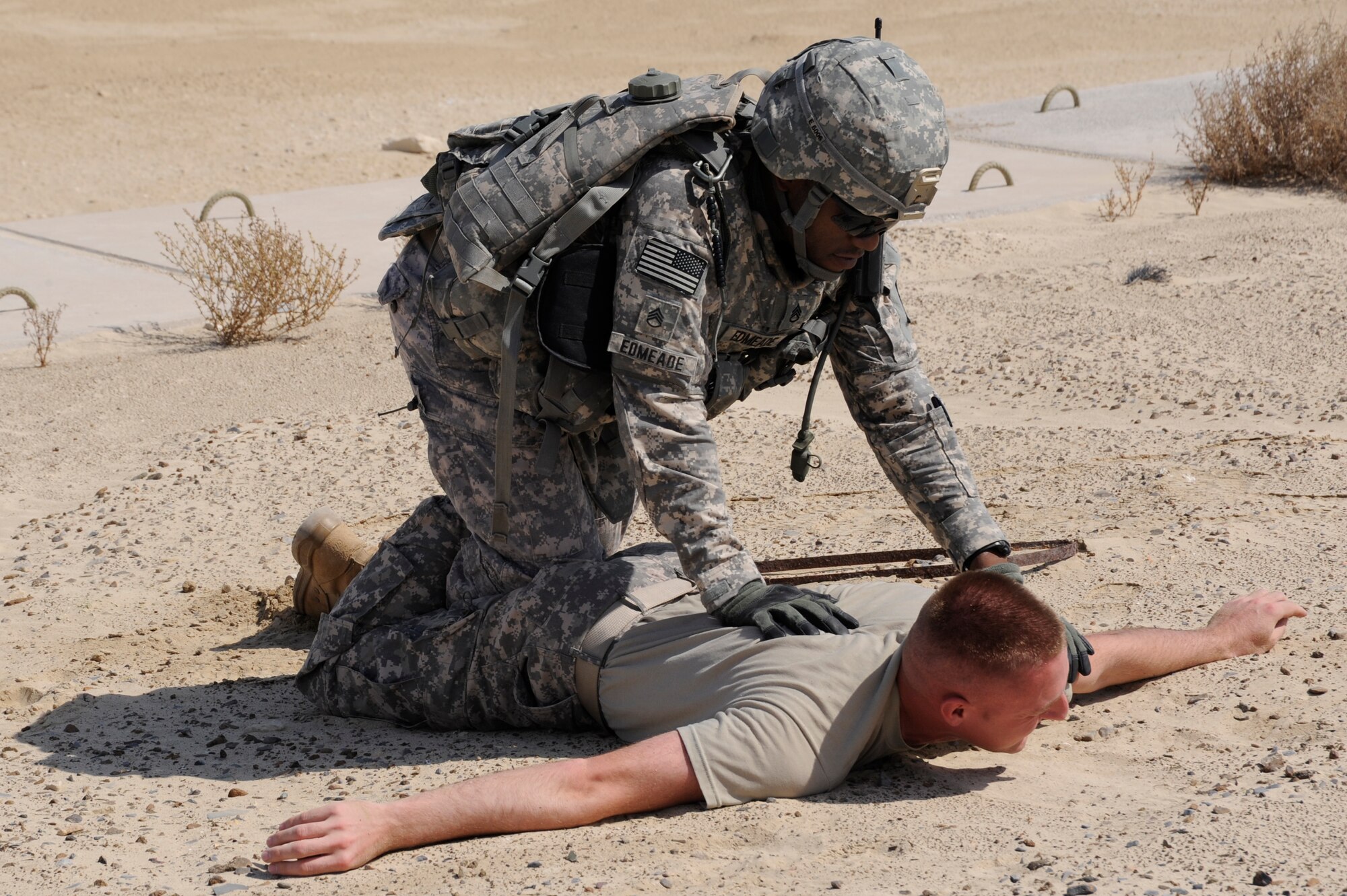 Army Staff Sgt. Luwi Edmeade, Headquarters and Headquarters Battery, 3rd
Battalion, 2nd Air Defense Artillery, searches a simulated suspect played by
Staff Sgt. Russell Porter, Headquarters and Headquarters Battery, 3rd
Battalion, 2nd Air Defense Artillery, during a force protection exercise on Oct. 27, 2010 at an undisclosed location in Southwest Asia. The exercise was a culmination of training that 3-2 ADA Soldiers received from 380th Expeditionary Security Forces Squadron Airmen. (U.S. Air Force photo/Tech. Sgt. April Wickes)

