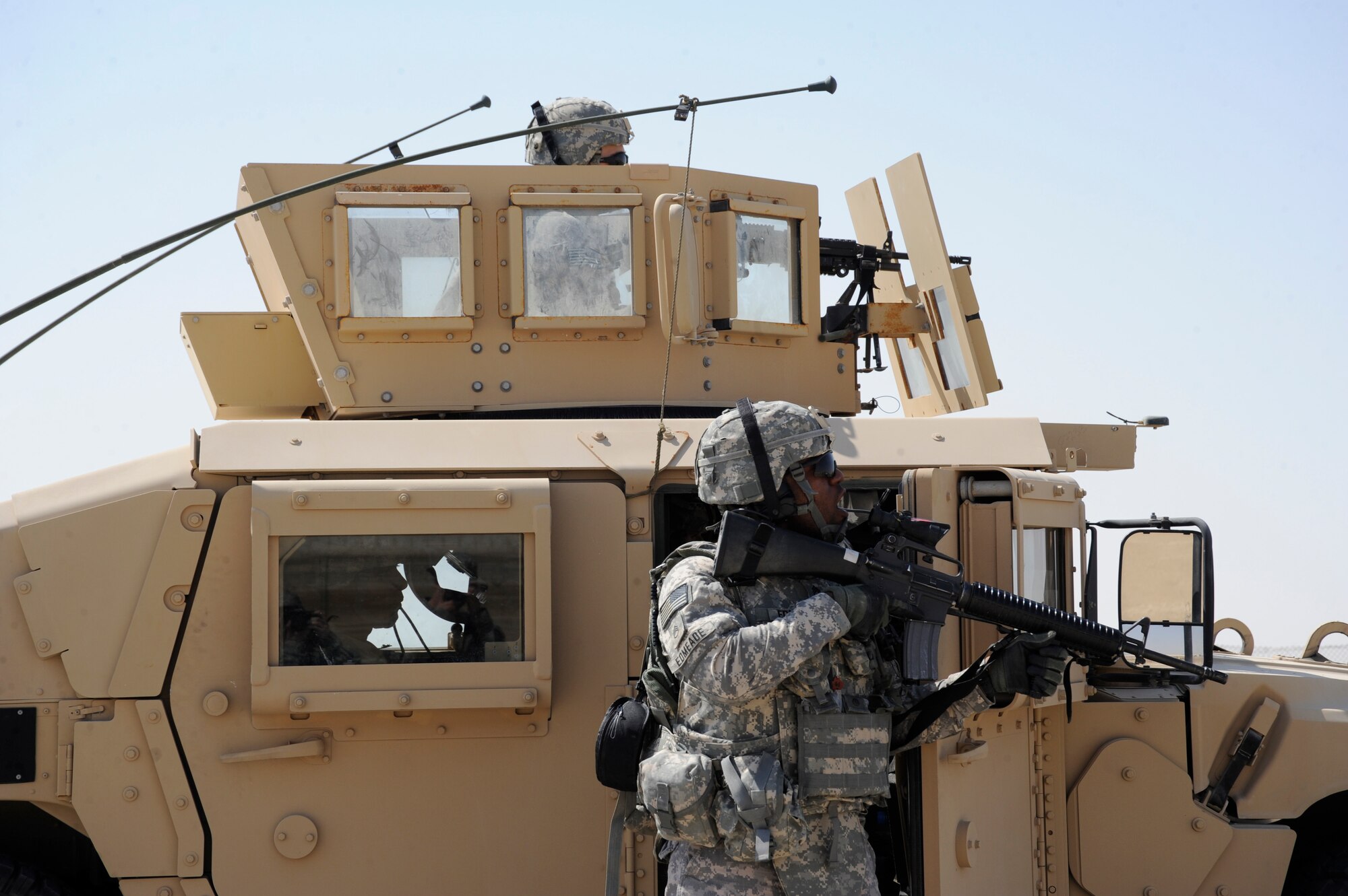 Spc. Russell Witcher and Staff Sgt. Luwi Edmeade, Headquarters and Headquarters Battery, 3rd Battalion, 2nd Air Defense Artillery, positionthemselves to perform a vehicle take down during a force protection exercise on Oct. 27, 2010 at an undisclosed location in Southwest Asia. The exercise was a culmination of training that 3-2 ADA Soldiers received from 380th Expeditionary Security Forces Squadron Airmen. (U.S. Air Force photo/Tech. Sgt. April Wickes)

